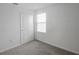 Bedroom featuring a window, neutral carpet, white walls, sliding closet doors, and star wall accents at 8563 Compass Point Ave, Orlando, FL 32832