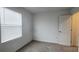 Bright bedroom featuring a window, neutral carpet, white walls and a bright source of natural light at 8563 Compass Point Ave, Orlando, FL 32832