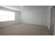 Spacious bedroom with plush carpet and a large window at 8563 Compass Point Ave, Orlando, FL 32832