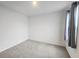 Clean bedroom features neutral carpet, white walls, a window with curtains, and a simple design at 8563 Compass Point Ave, Orlando, FL 32832