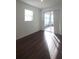 Bedroom showcasing new laminate wood flooring and a sliding glass door to a patio at 8563 Compass Point Ave, Orlando, FL 32832
