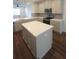 Spacious kitchen featuring an island, modern appliances, and ample cabinet space at 8563 Compass Point Ave, Orlando, FL 32832