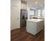 Kitchen with a center island, stainless steel refrigerator, and plenty of storage at 8563 Compass Point Ave, Orlando, FL 32832