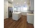 Kitchen featuring a central island, stainless steel appliances, and sleek countertops at 8563 Compass Point Ave, Orlando, FL 32832