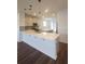 Open kitchen showcasing a large countertop bar, island, and modern pendant lighting at 8563 Compass Point Ave, Orlando, FL 32832