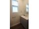 Powder room with a vanity and window offering natural light at 8563 Compass Point Ave, Orlando, FL 32832
