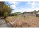 View of a spacious backyard featuring a wood deck, patio, a shed, partial fence and mature trees at 1010 Timor Ave, Orlando, FL 32804