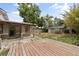Spacious backyard featuring a wood deck, patio, a shed, partial fence and mature trees at 1010 Timor Ave, Orlando, FL 32804