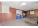 The basement has carpet and brick walls with storage and access to the outside at 1010 Timor Ave, Orlando, FL 32804