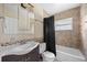 Bathroom featuring tiled shower and tub, stylish mosaic trim, vanity with single sink and medicine cabinet at 1010 Timor Ave, Orlando, FL 32804