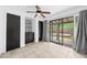Bright bedroom featuring tile floors, ceiling fan, dual closets and sliding glass door to the backyard deck at 1010 Timor Ave, Orlando, FL 32804