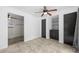 Bright bedroom featuring tile floors, ceiling fan, dual closets and access to a closet-lined bedroom at 1010 Timor Ave, Orlando, FL 32804
