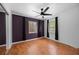 Bedroom featuring wood laminate flooring, light walls, two windows, and ceiling fan with light fixture at 1010 Timor Ave, Orlando, FL 32804