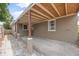 Spacious carport that provides protection from the elements with a rustic looking open rafter ceiling design at 1010 Timor Ave, Orlando, FL 32804