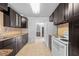 Updated kitchen features granite countertops, dark cabinetry, tiled backsplash, and stainless steel appliances at 1010 Timor Ave, Orlando, FL 32804