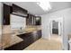 The kitchen showcases granite countertops, dark cabinets, stainless steel appliances, and tiled flooring at 1010 Timor Ave, Orlando, FL 32804