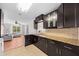 The kitchen boasts granite countertops, dark cabinets, stainless steel appliances, and tiled floors at 1010 Timor Ave, Orlando, FL 32804