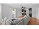 Open-concept living area with hardwood floors, ceiling fan, comfortable couch, and access to a stylish kitchenette at 1010 Timor Ave, Orlando, FL 32804