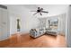 Bright living room features wood floors, ceiling fan, large windows, and a comfortable sectional sofa at 1010 Timor Ave, Orlando, FL 32804