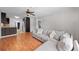Comfortable living room features wood floors, a ceiling fan, and a large sectional sofa at 1010 Timor Ave, Orlando, FL 32804