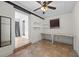 Room with tile flooring, built-in shelving and table, and a window with blinds at 1010 Timor Ave, Orlando, FL 32804