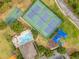 An aerial shot showcases a community with a pool, tennis courts, basketball court, playground, and ample parking at 10142 Hidden Dunes Ln, Orlando, FL 32832