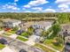 Beautiful, two-story light-blue home with palm trees, a brick driveway, and a pond view at 10142 Hidden Dunes Ln, Orlando, FL 32832