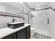 Bathroom featuring black vessel sink, black hardware, and walk-in shower with glass door at 10142 Hidden Dunes Ln, Orlando, FL 32832