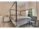 Bedroom features a four-poster bed, large window and light-filled atmosphere at 10142 Hidden Dunes Ln, Orlando, FL 32832