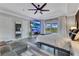 Bright bedroom with tray ceiling, ceiling fan, and balcony access overlooking the beautiful backyard at 10142 Hidden Dunes Ln, Orlando, FL 32832