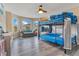 Bedroom featuring a bunk bed with blue bedding, bay window and wood-look floors at 10142 Hidden Dunes Ln, Orlando, FL 32832
