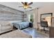 Bedroom with unique accent wall, wood-look floors and lots of natural light at 10142 Hidden Dunes Ln, Orlando, FL 32832