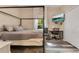 Bedroom with a four-poster bed, large window, tv, and desk at 10142 Hidden Dunes Ln, Orlando, FL 32832