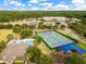 Aerial view of the community pool, tennis courts, school, and playground at 10142 Hidden Dunes Ln, Orlando, FL 32832