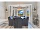 Dining area with a decorative chandelier, white cabinets, a large window and views of the backyard at 10142 Hidden Dunes Ln, Orlando, FL 32832