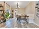 The dining room showcases modern light fixture and ample seating, perfect for Gathering gatherings at 10142 Hidden Dunes Ln, Orlando, FL 32832
