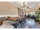 An elegant dining area with wood flooring and dining table and chairs is perfect for entertaining at 10142 Hidden Dunes Ln, Orlando, FL 32832