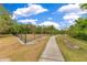 Community dog park featuring a paved walking path for residents to enjoy at 10142 Hidden Dunes Ln, Orlando, FL 32832