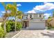 Beautiful two-story home featuring a well-manicured front yard, paved driveway and attractive architectural details at 10142 Hidden Dunes Ln, Orlando, FL 32832