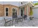 Cozy front patio with outdoor seating and stone accents provides a welcoming entrance to the home at 10142 Hidden Dunes Ln, Orlando, FL 32832