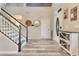 Inviting foyer featuring wood-look floors, staircase and natural light creates a warm and welcoming entry at 10142 Hidden Dunes Ln, Orlando, FL 32832