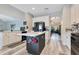 Bright open kitchen features a center island with a marble countertop, modern appliances, and light wood floors at 10142 Hidden Dunes Ln, Orlando, FL 32832