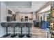 Open concept kitchen with a breakfast bar, light wood flooring, and updated stainless steel appliances at 10142 Hidden Dunes Ln, Orlando, FL 32832