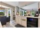 Kitchenette area featuring bright cabinets, modern appliances, and views to the backyard at 10142 Hidden Dunes Ln, Orlando, FL 32832