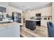 Updated kitchen with a center island, modern appliances, white cabinets and light wood flooring at 10142 Hidden Dunes Ln, Orlando, FL 32832