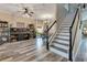 Spacious living room with wood floors offering room for a large aquarium and dining area at 10142 Hidden Dunes Ln, Orlando, FL 32832