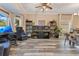 Open-concept living space with desk area featuring wood floors and a large window providing natural light at 10142 Hidden Dunes Ln, Orlando, FL 32832