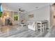 Bright living room features a large sectional sofa, ceiling fan and modern decor at 10142 Hidden Dunes Ln, Orlando, FL 32832