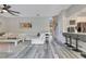 Open living area features bar seating, light wood floors, and a modern entertainment center at 10142 Hidden Dunes Ln, Orlando, FL 32832