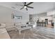 Bright, open living room with a large sectional sofa and view to the kitchen at 10142 Hidden Dunes Ln, Orlando, FL 32832